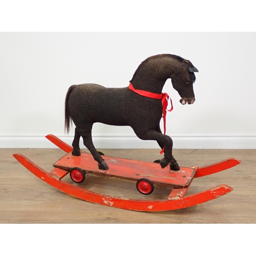 777 - A fabric Rocking Horse on red painted base 3ft 9in L