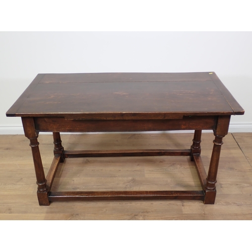 779 - An oak Refectory Table in the 17th Century style with cleated plank top on turned supports with surr... 