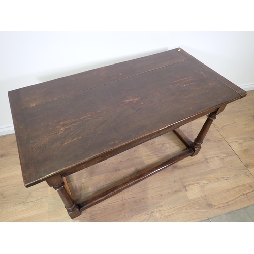 779 - An oak Refectory Table in the 17th Century style with cleated plank top on turned supports with surr... 