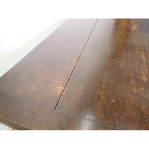 779 - An oak Refectory Table in the 17th Century style with cleated plank top on turned supports with surr... 