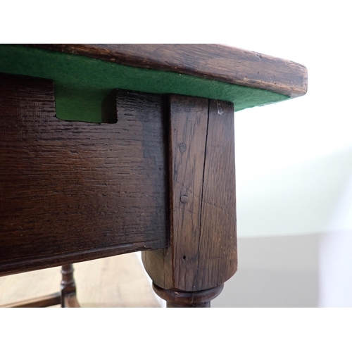 779 - An oak Refectory Table in the 17th Century style with cleated plank top on turned supports with surr... 