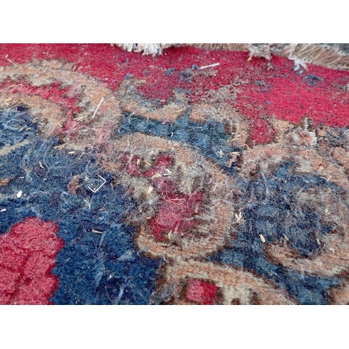 788 - A large Chinese red ground Carpet with blue central floral lozenge and broad borders 13ft L x 10ft W... 