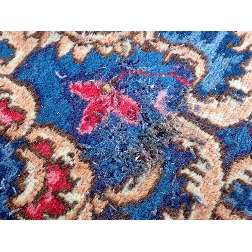 788 - A large Chinese red ground Carpet with blue central floral lozenge and broad borders 13ft L x 10ft W... 