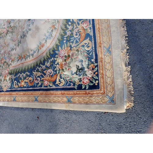 79 - A Chinese blue ground Carpet with floral design and beige multiple borders 12ft 3in x 9ft 1in, some ... 