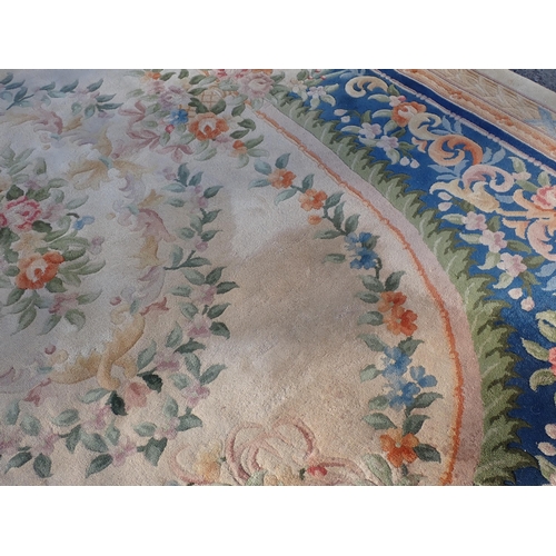 79 - A Chinese blue ground Carpet with floral design and beige multiple borders 12ft 3in x 9ft 1in, some ... 