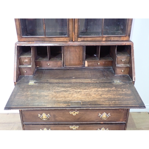 831 - A Georgian walnut Bureau Bookcase with glazed upper section above base fitted fall front enclosing f... 