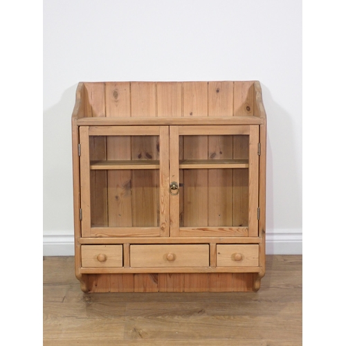 92 - A pine and glazed two door Wall Cabinet 2ft 5in H x 2ft 1in W