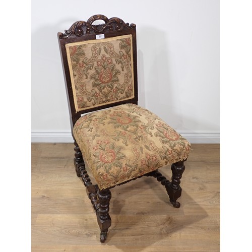 557 - A set of six Victorian carved oak Dining Chairs with needlework upholstered backs and seats