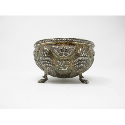 103 - An Oriental silver Bowl, embossed and chased with fish, animals and leafage on paw feet, 4in diam