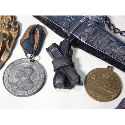 295 - A white metal bag top, a small embossed brass Panel, ceramic figure of a child, a copper Dish, medal... 