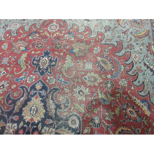 299 - A Persian Carpet of multi-bordered design with floral and scrolled design, on a red ground, 11ft 5in... 