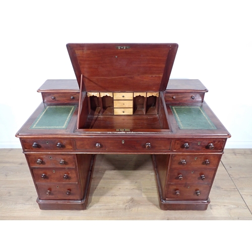 315 - A Victorian mahogany twin pedestal Desk with sloped leather inset writing surface fitted nine drawer... 