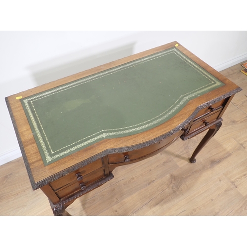 348 - An Edwardian mahogany Desk with green leather inset writing surface above five drawers mounted upon ... 