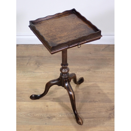 355 - A Georgian mahogany Kettle Stand with slide mounted upon turned column and tripod supports terminati... 