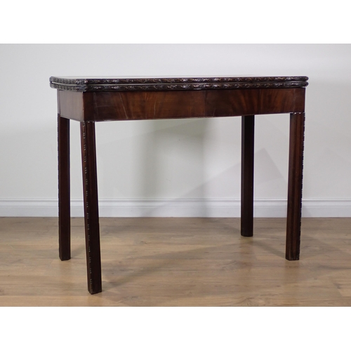 358 - A George III mahogany serpentine fronted fold-over Tea Table with floral carved edge and chamfered c... 