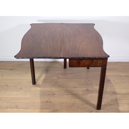 358 - A George III mahogany serpentine fronted fold-over Tea Table with floral carved edge and chamfered c... 