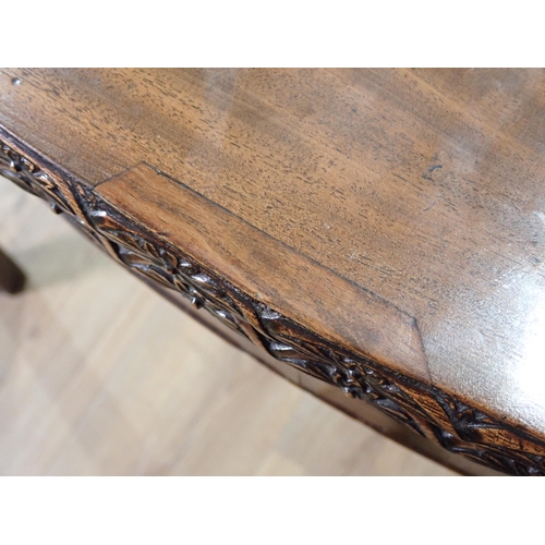 358 - A George III mahogany serpentine fronted fold-over Tea Table with floral carved edge and chamfered c... 