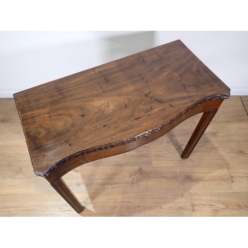 358 - A George III mahogany serpentine fronted fold-over Tea Table with floral carved edge and chamfered c... 