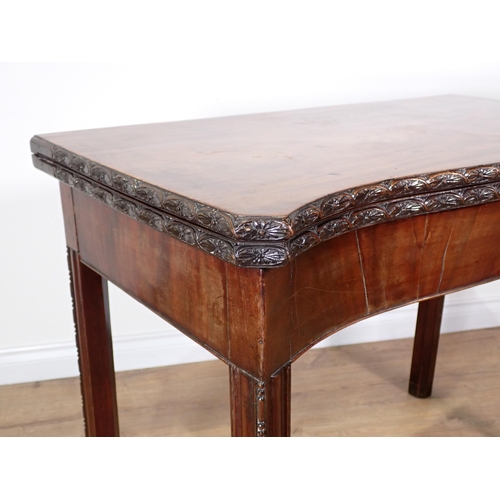 358 - A George III mahogany serpentine fronted fold-over Tea Table with floral carved edge and chamfered c... 