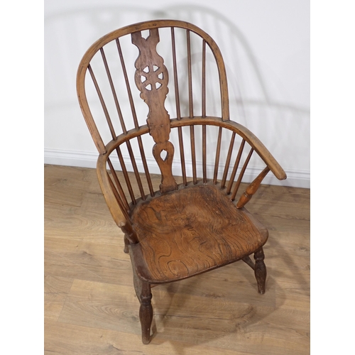 366 - A 19th Century ash and elm Windsor Elbow Chair with wheel pierced splat back on turned supports and ... 