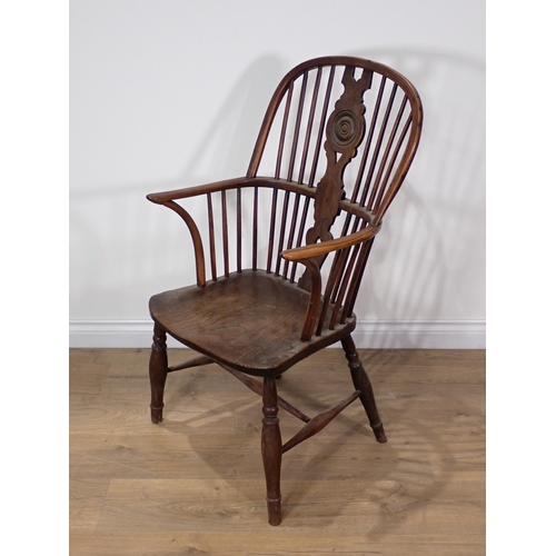 368 - A 19th Century elm and yew Windsor Elbow Chair with roundel moulded and pierced splat back on turned... 