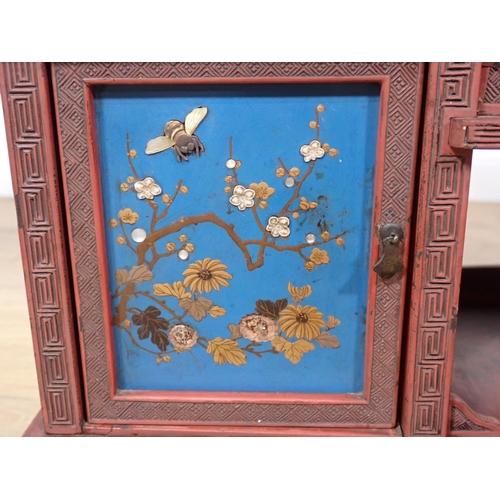 379 - A Japanese Shibayama red and blue lacquered Table Cabinet fitted pair of sliding doors, cupboard doo... 