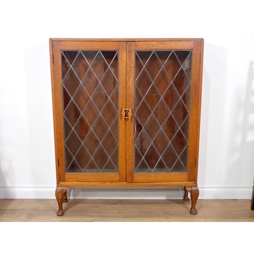 391 - An oak and lead glazed two door Bookcase, an oak dropleaf Occasional Table and four ladderback Dinin... 