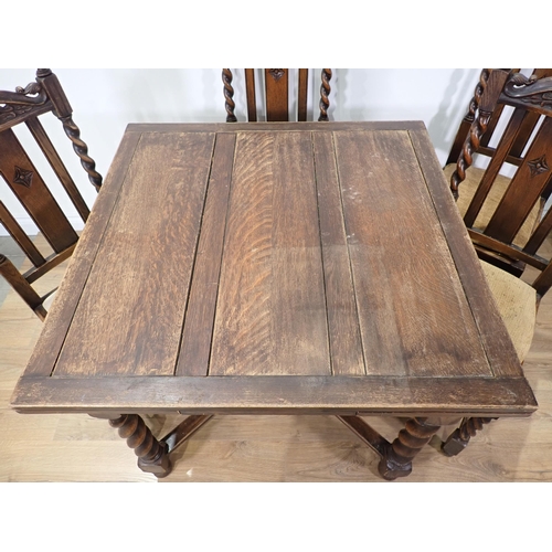 393 - An oak draw leaf Dining Table on barley twist supports, four Dining Chairs and a Court Cupboard