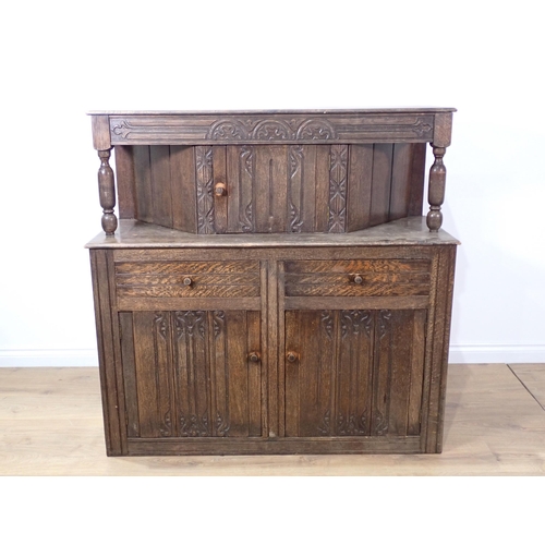 393 - An oak draw leaf Dining Table on barley twist supports, four Dining Chairs and a Court Cupboard