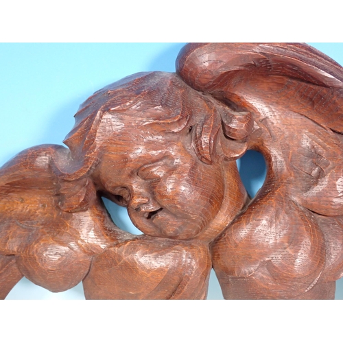 492 - A pair of antique carved oak Angels in the 18th Century style