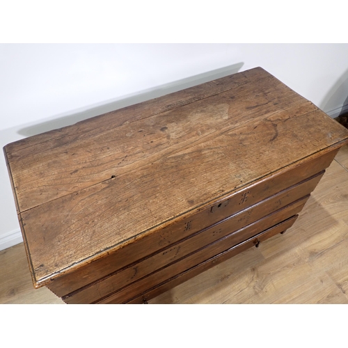 534 - An 18th Century elm Mule Chest of plank construction  with studwork date '1745' fitted lower drawer ... 