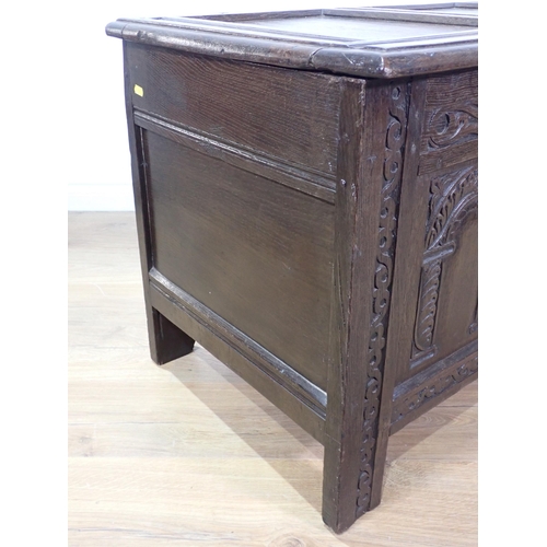 535 - A late 17th Century joined oak Coffer with sunken three panel lid above front with three arched carv... 