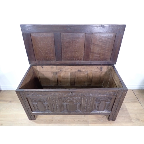 535 - A late 17th Century joined oak Coffer with sunken three panel lid above front with three arched carv... 