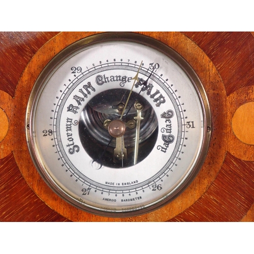 561 - A mahogany circular aneroid Barometer with inlay of racing pigeons 9in D