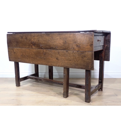 584 - An 18th Century and later dropleaf Table fitted drawer to each end mounted upon square cut chamfered... 