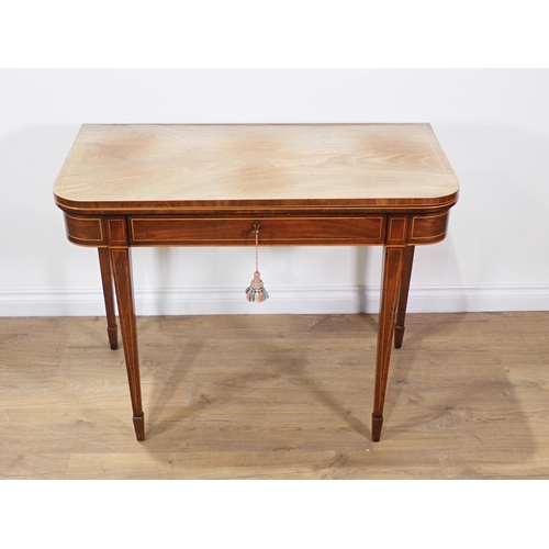 611 - A 19th Century mahogany and boxwood strung fold-over Tea Table mounted on square cut tapering suppor... 