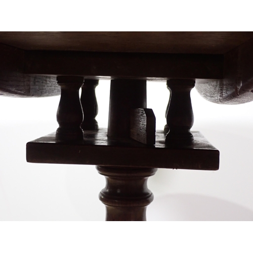 636 - An 18th Century oak Pillar Table with birdcage action on baluster turned column and tripod base 2ft ... 