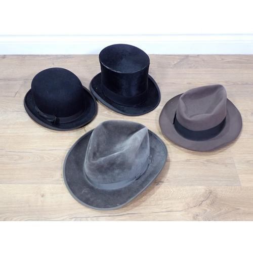 640 - A black silk Top Hat 7 1/2in, a black Bowler Hat and two Trilbys