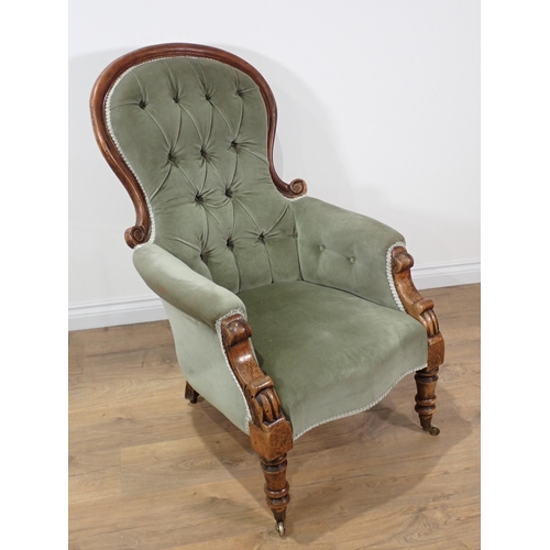 654 - A Victorian mahogany framed green upholstered button back Armchair on turned supports