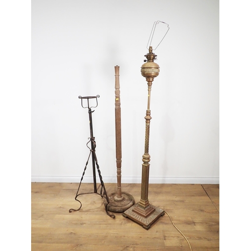 655 - An antique brass Standard Lamp converted from an oil lamp 5ft 4in H, a fluted oak Standard Lamp and ... 