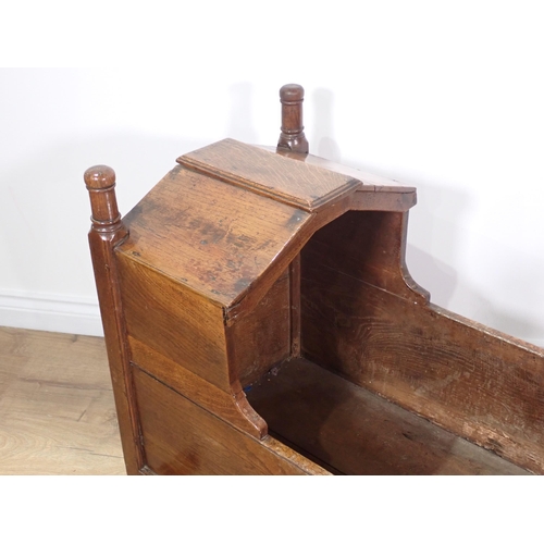 663 - An antique oak Cradle with turned finials and shaped canopy