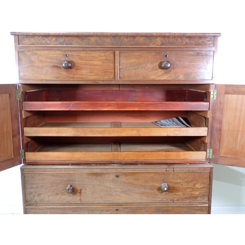 670 - A 19th Century mahogany Linen Press Cupboard with two small drawers above a pair of cupboard doors e... 