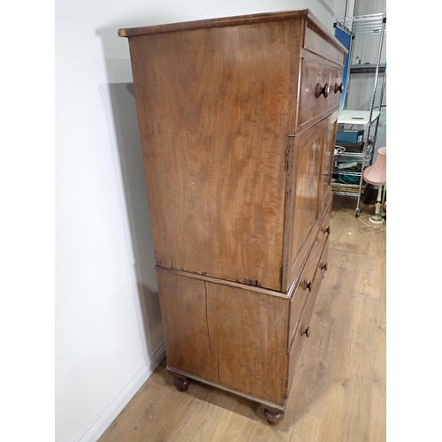 670 - A 19th Century mahogany Linen Press Cupboard with two small drawers above a pair of cupboard doors e... 