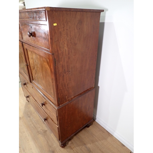 670 - A 19th Century mahogany Linen Press Cupboard with two small drawers above a pair of cupboard doors e... 