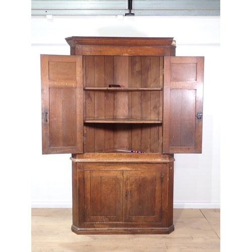 715 - An antique oak standing Corner Cupboard fitted four doors 7ft 3in H x 4ft W