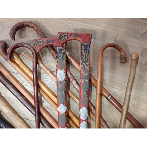 82 - A quantity of Walking Sticks, Shooting Stick, two Aborigine type Sticks, etc.