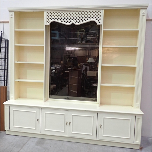 741 - A cream painted Bookcase/Cabinet with central mirror back having pierced frieze flanked by open shel... 