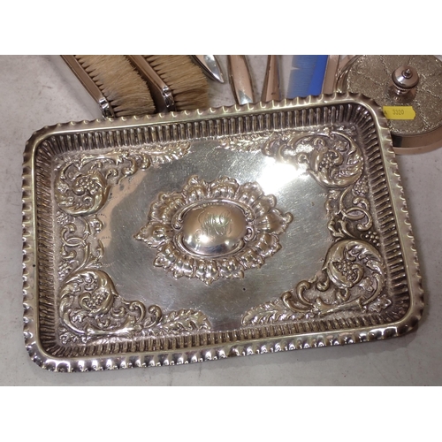 502 - An engine turned silver Dressing Table Set, a plated Condiment Set on stand, an embossed Tray, a pla... 