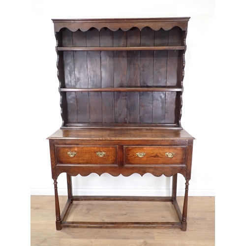 559 - An oak Dresser and Rack in the 18th Century style fitted two drawers above shaped frieze 6ft 2in H x... 