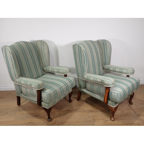 575 - A pair of blue upholstered Wingback Armchairs on cabriole supports